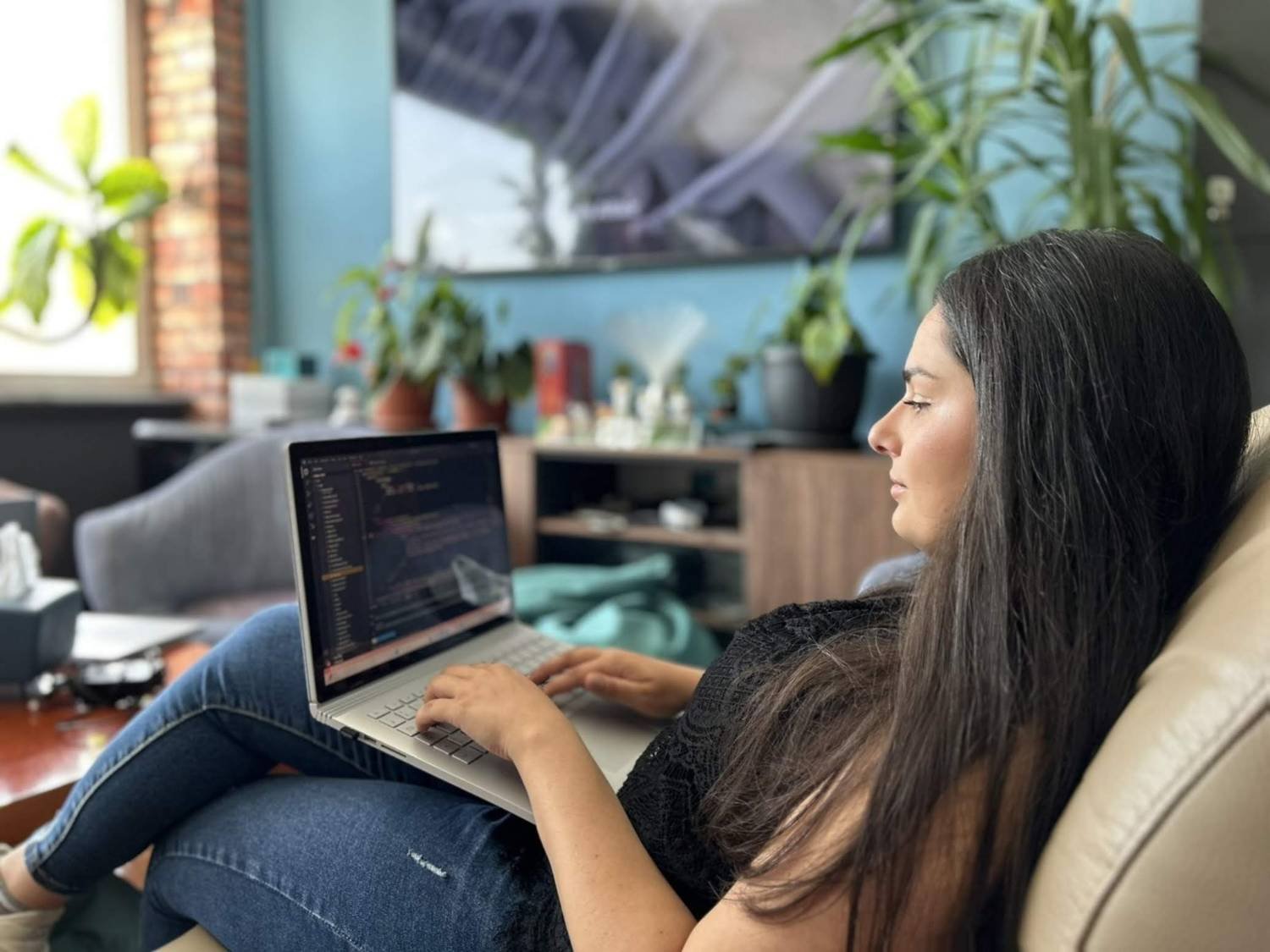 Marija Buteska coding on a laptop in a bright studio